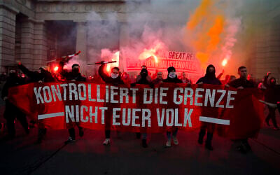 Demonstrators shout slogans and light flares during a demonstration against measures to battle the coronavirus pandemic in Vienna, Austria, Saturday, Nov. 20, 2021. (AP Photo/Florian Schroetter)