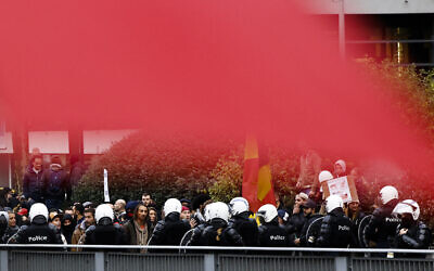 Police officers clash with protesters during a demonstration against the reinforced measures of the Belgium government to counter the latest spike of the coronavirus in Brussels, Belgium,  Nov. 21, 2021. (Olivier Matthys/AP)
