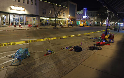 Police tape cordons off a street in Waukesha, Wis., after a vehicle plowed into a Christmas parade hitting more than 20 people Sunday, Nov. 21, 2021. (AP Photo/Jeffrey Phelps)