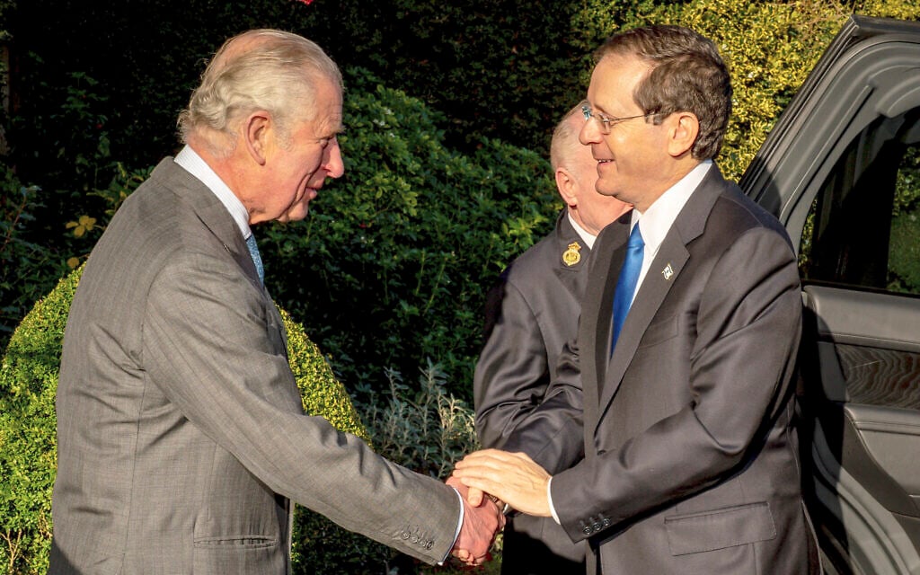 Britain's Prince Charles, left, welcomes Israeli President Isaac Herzog at Highgrove House, Tetbury, England, Monday November 22, 2021. (Ben Birchall/Pool Photo via AP)