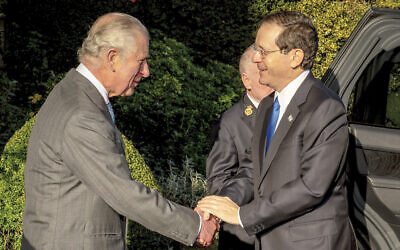 Britain's Prince Charles, left, welcomes Israeli President Isaac Herzog at Highgrove House, Tetbury, England, Monday November 22, 2021. (Ben Birchall/Pool Photo via AP)