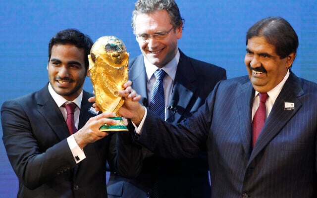 Mohamed bin Hamad Al-Thani, left, Chairman of the 2022 bid committee, and Sheikh Hamad bin Khalifa Al-Thani, Emir of Qatar, hold the World Cup trophy in front of FIFA Secretary General Jerome Valcke after the announcement that Qatar will host the 2022 soccer World Cup, made in Zurich, Switzerland, on Dec. 2, 2010. (Anja Niedringhaus/AP) Mohamed bin Hamad Al-Thani, left, Chairman of the 2022 bid committee, and Sheikh Hamad bin Khalifa Al-Thani, Emir of Qatar, hold the World Cup trophy in front of FIFA Secretary General Jerome Valcke after the announcement that Qatar will host the 2022 soccer World Cup, made in Zurich, Switzerland, on Dec. 2, 2010. (Anja Niedringhaus/AP)