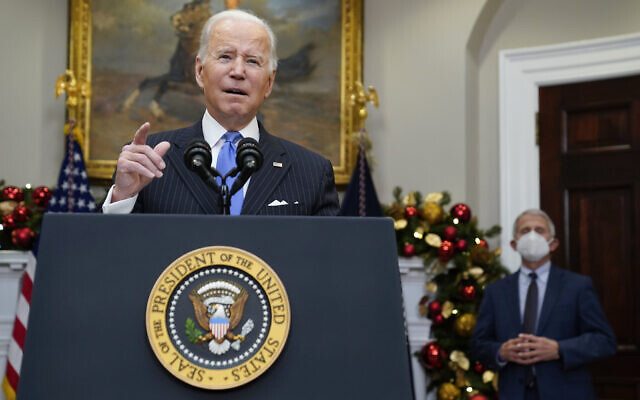 US President Joe Biden speaks about the COVID-19 Omicron variant, in the Roosevelt Room of the White House, November 29, 2021, in Washington, as Dr. Anthony Fauci, director of the National Institute of Allergy and Infectious Diseases, listens. (AP Photo/ Evan Vucci) US President Joe Biden speaks about the COVID-19 Omicron variant, in the Roosevelt Room of the White House, November 29, 2021, in Washington, as Dr. Anthony Fauci, director of the National Institute of Allergy and Infectious Diseases, listens. (AP Photo/ Evan Vucci)