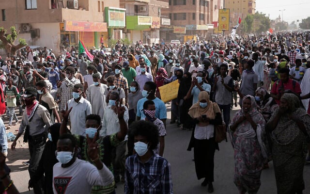 Tens of thousands of Sudanese calling for a civilian government march near the presidential palace in Khartoum, Sudan, on November 30, 2021. (AP Photo/Marwan Ali) Tens of thousands of Sudanese calling for a civilian government march near the presidential palace in Khartoum, Sudan, on November 30, 2021. (AP Photo/Marwan Ali)
