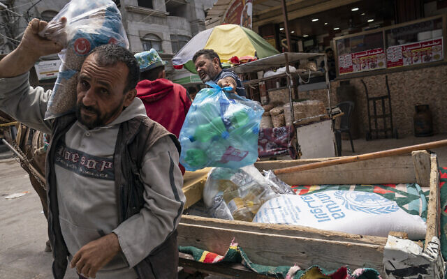 A bag of foodstuffs provided by the UN agency for Palestinian refugees (UNRWA) lies in a cart as Palestinians collect food aid following a cease-fire reached after an 11-day military conflict between Gaza's Hamas rulers and Israel, in Gaza City, on May 22, 2021. (AP Photo/John Minchillo, File) A bag of foodstuffs provided by the UN agency for Palestinian refugees (UNRWA) lies in a cart as Palestinians collect food aid following a cease-fire reached after an 11-day military conflict between Gaza's Hamas rulers and Israel, in Gaza City, on May 22, 2021. (AP Photo/John Minchillo, File)