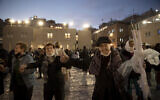 Holocaust survivors dance during a Hanukkah menorah lighting ceremony at the Western Wall, in the Old City of Jerusalem, on Tuesday, November 30, 2021. (AP Photo/Maya Alleruzzo)