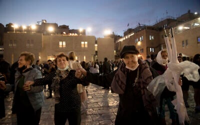 Holocaust survivors dance during a Hanukkah menorah lighting ceremony at the Western Wall, in the Old City of Jerusalem, on Tuesday, November 30, 2021. (AP Photo/Maya Alleruzzo)