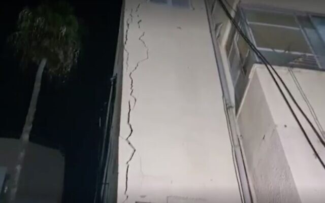 Screen capture from video of an apartment building in Bat Yam that was evacuated due to fears it would collapse, on November 16, 2021. (Ynet) Screen capture from video of an apartment building in Bat Yam that was evacuated due to fears it would collapse, on November 16, 2021. (Ynet)