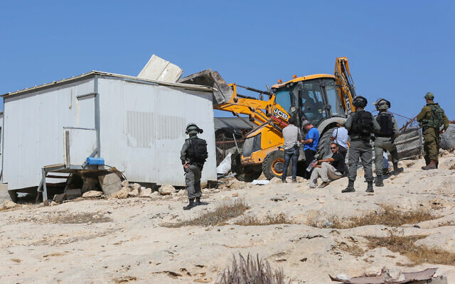 A JCB excavator operated by Israeli authorities demolishes homes belonging to Palestinians, in the village of al-Mufagra near the West Bank city of Yatta, on September 11, 2019. (Wisam Hashlamoun/Flash90) A JCB excavator operated by Israeli authorities demolishes homes belonging to Palestinians, in the village of al-Mufagra near the West Bank city of Yatta, on September 11, 2019. (Wisam Hashlamoun/Flash90)