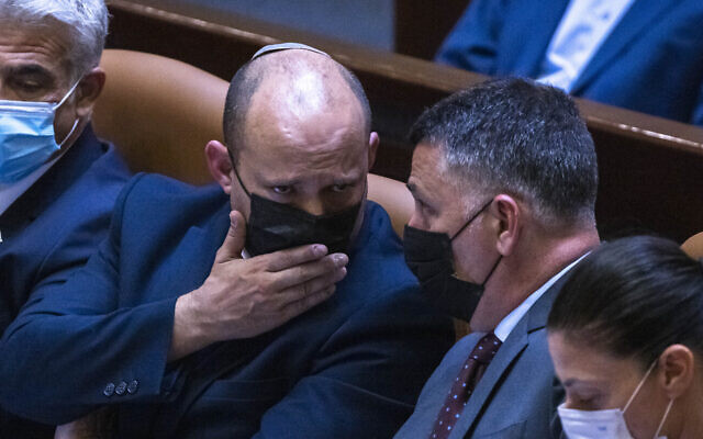 Prime Minister Naftali Bennett (left) speaks with Justice Minister Gideon Sa'ar in the Knesset, on June 28, 2021. (Olivier Fitoussi/Flash90) Prime Minister Naftali Bennett (left) speaks with Justice Minister Gideon Sa'ar in the Knesset, on June 28, 2021. (Olivier Fitoussi/Flash90)
