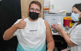 An Israeli receives a third dose of the COVID-19 vaccine at a Maccabi Health Care center in Katsrin, Golan Heights, October 7, 2021. (Michael Giladi/Flash90)