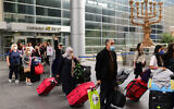Travelers seen exiting Ben Gurion International Airport, as Israel opens its borders and allows tourists to enter the country after months of being shut due to the COVID-19 pandemic, November 1, 2021. (Tomer Neuberg/Flash90)