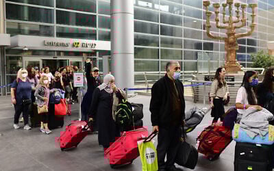 Travelers seen exiting Ben Gurion International Airport, as Israel opens its borders and allows tourists to enter the country after months of being shut due to the COVID-19 pandemic, November 1, 2021. (Tomer Neuberg/Flash90)