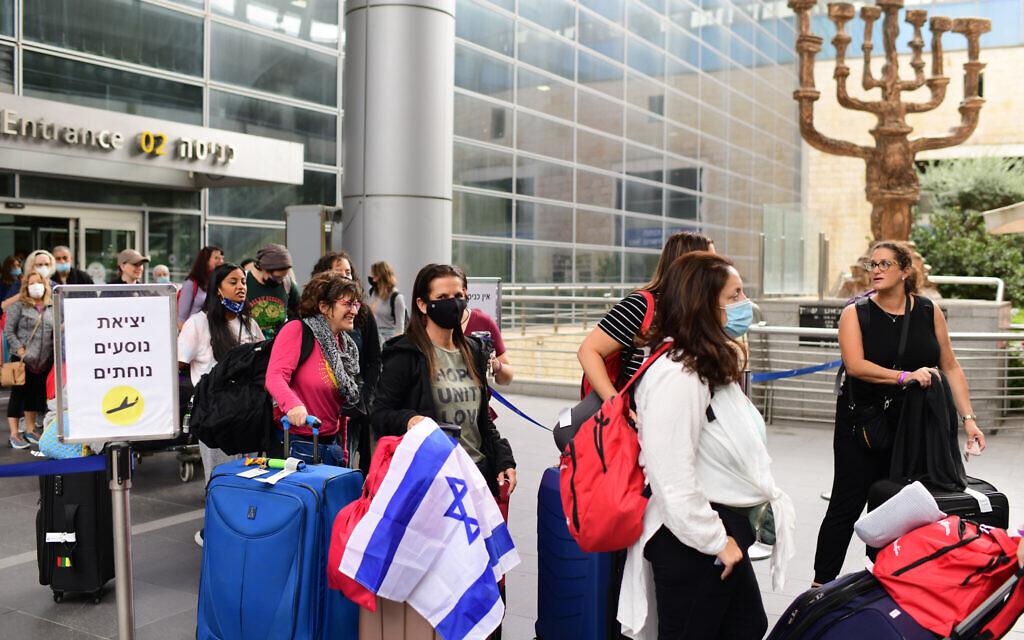 Travelers seen exiting Ben Gurion International Airport, as Israel opens its borders and allows tourists to enter the country, after months of being shut due to the COVID-19 pandemic, November 1, 2021. (Tomer Neuberg/FLASH90 Travelers seen exiting Ben Gurion International Airport, as Israel opens its borders and allows tourists to enter the country, after months of being shut due to the COVID-19 pandemic, November 1, 2021. (Tomer Neuberg/FLASH90