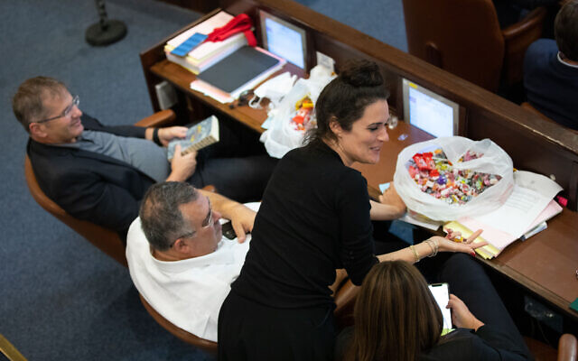 Likud MK David Bitan with a bag of candy in the Knesset on November 3, 2021 (Olivier Fitoussi/Flash90) Likud MK David Bitan with a bag of candy in the Knesset on November 3, 2021 (Olivier Fitoussi/Flash90)