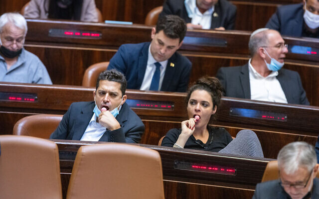 Lawmakers eat lollipops in the Knesset in Jerusalem on November 3, 2021 (Olivier Fitoussi/Flash90) Lawmakers eat lollipops in the Knesset in Jerusalem on November 3, 2021 (Olivier Fitoussi/Flash90)