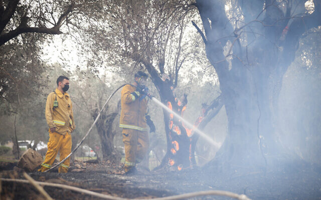 Firefighters work to extinguish a fire in Ma'alot-Tarshiha, northern Israel, on November 14, 2021 (David Cohen/Flash90)