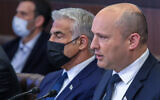 Prime Minister Naftali Bennett (R) and Foreign Minister Yair Lapid during a cabinet meeting at the Prime Minister's Office in Jerusalem on November 14, 2021. (Marc Israel Sellem/POOL)