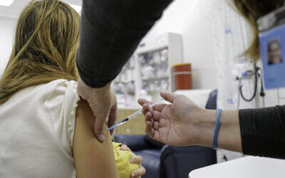 A COVID-19 vaccine being given at health center on the Golan Heights, November 16, 2021. (Michael Giladi/Flash90)