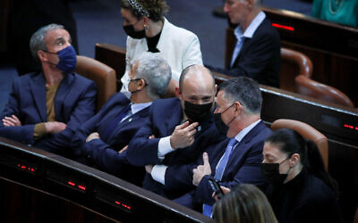 Prime Minister Naftali Bennett (C) during a vote on a bill limiting prime ministers to eight years in office, at the Knesset in Jerusalem, November 22, 2021. (Yonatan Sindel/Flash90)