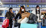 A woman is seen speaking on her phone at Ben Gurion Airport, on November 28, 2021. (Avshalom Sassoni/Flash90)