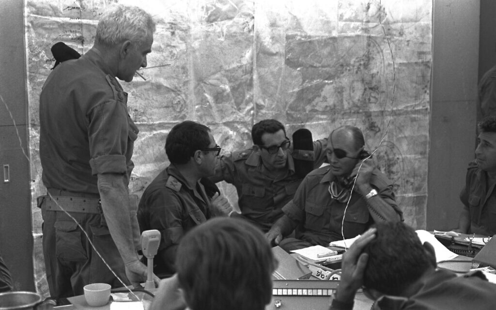 Israeli Defense Minister Moshe Dayan in the war room at Israel Defense Forces headquarters, Tel Aviv, on October 8, 1973. On Dayan’s right are General Rehavam Ze'evi, General Shmuel Gonen and General Uri Ben-Ari (GPO/ Arad Shlomo).