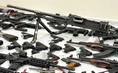 A machine gun and other illegal weapons sezied in police raids for arms in the Arab community, November 9, 2021. (Israel Police)