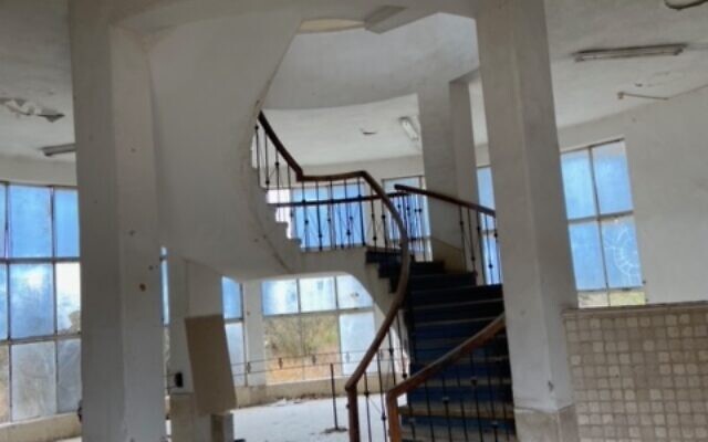 The central staircase of the abandoned terminal building of Jerusalem Airport at Atarot, November 2021. (David Horovitz / Times of Israel)