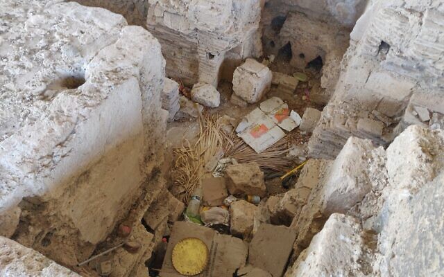 An ancient Roman and Byzantine bathhouse unearthed in Tiberias lies neglected, under piles of garbage and housing a homeless person, October 19, 2021. (Michael Bachner/Times of Israel)