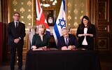 Foreign Minister Yair Lapid (R) signs an MOU with UK Foreign Secretary Liz Truss at the Foreign Office, in London, November 29, 2021. (Stuart Mitchell/ GPO)