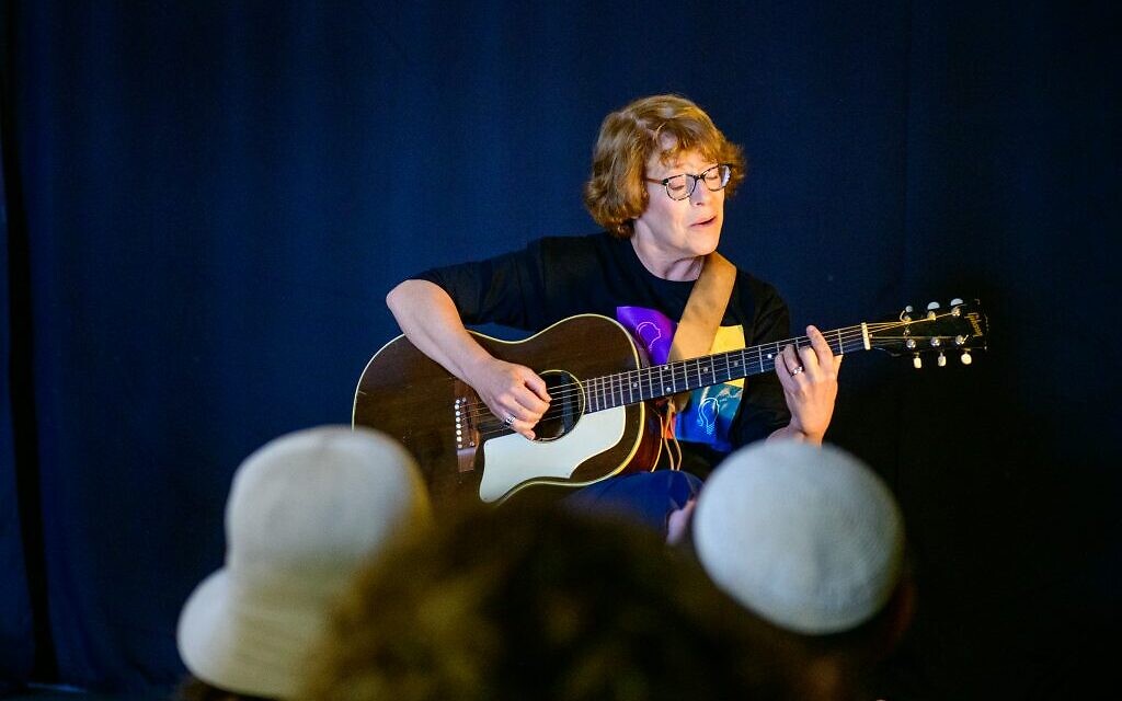 A Jewish Life Photo Bank stock photo of a woman playing guitar in concert. (Courtesy/ Jewish Life Photo Bank)