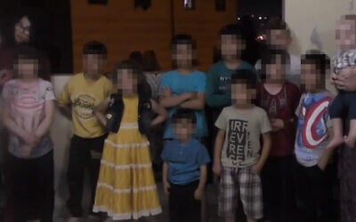 In this photo released November 17, 2021, by the B'Tselem human right group, children are lined up by IDF soldiers in Hebron to have their pictures taken. (B'Tselem)