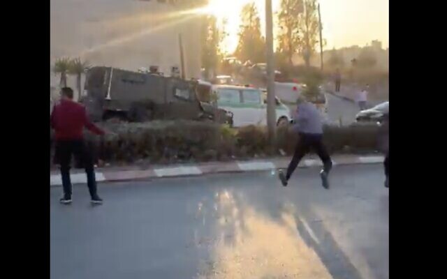 In video uploaded to social media on November 8, 2021, Palestinians are seen throwing rocks at a Border Police jeep that entered the West Bank city of Ramallah. (Screen capture: Twitter) In video uploaded to social media on November 8, 2021, Palestinians are seen throwing rocks at a Border Police jeep that entered the West Bank city of Ramallah. (Screen capture: Twitter)