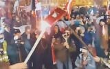 Nationalist rally-goers burn a book representing a historic pact protecting the rights of Poland’s Jews in Kalisz, Poland, Nov. 11, 2021. (Screenshot from Karolina Pawliczak/Twitter)