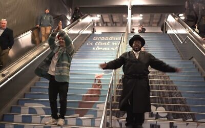 Screenshot from a video of Kosha Dillz, left, and Nissim Black performing across Midtown Manhattan in the video to 'The Hanukkah Song 2.0.' (JTA)