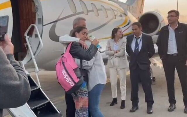 Mordy and Natali Oknin embrace their daughter Shiraz after landing back in Israel on November 18, 2021 (Screencapture/Airport's Authority) Mordy and Natali Oknin embrace their daughter Shiraz after landing back in Israel on November 18, 2021 (Screencapture/Airport's Authority)