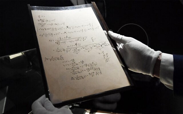 Pages of one of the preparatory manuscript to the theory of general relativity of Albert Einstein, during their presentation a day before being auctioned at Christie's auction house in Paris, on November 22, 2021. (Alain Jocard/AFP) Pages of one of the preparatory manuscript to the theory of general relativity of Albert Einstein, during their presentation a day before being auctioned at Christie's auction house in Paris, on November 22, 2021. (Alain Jocard/AFP)
