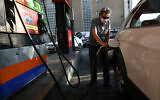 A man fills his car at a gas station amid a cyber attack on the nation's fuel system, in Tehran, Iran, October 27, 2021. (AP Photo/Vahid Salemi)