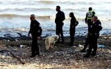 Police officers are seen at Sea of Galilee's Migdal beach, near where the body of an unidentified man was found, November 13, 2021. (Courtesy)