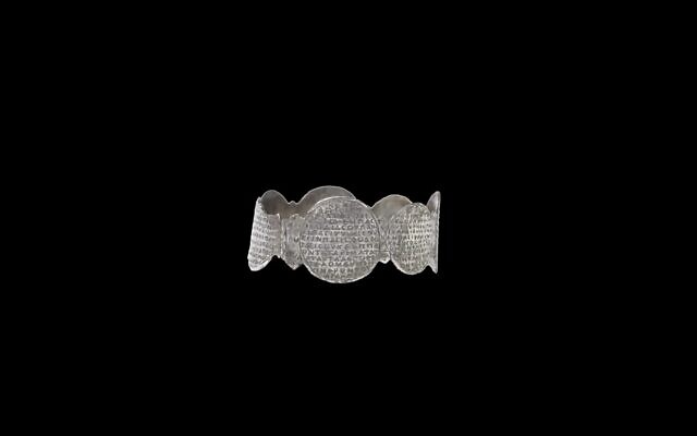 The 1,500-year-old silver cuff inscribed with the words of the Shema prayer in Greek, forms the center of 'Hear, O Israel: The Magic of the Shema,' a new archaeological exhibit at the Israel Museum that closes April 2022. (Courtesy Elie Posner)