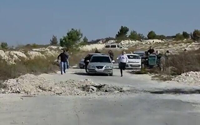 Settlers chase after Palestinians near the West Bank outpost of Homesh on November 15, 2021. (Yesh Din/Screenshot) Settlers chase after Palestinians near the West Bank outpost of Homesh on November 15, 2021. (Yesh Din/Screenshot)