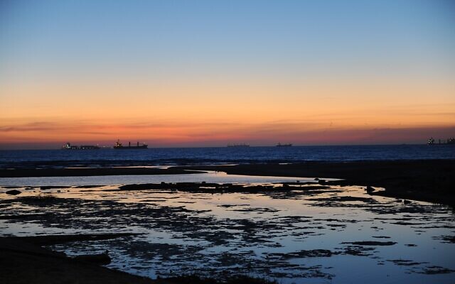 Ships seen at sunset off the coast of the southern Israeli city of Ashdod, on May 13, 2019. (Mendy Hechtman/Flash90) Ships seen at sunset off the coast of the southern Israeli city of Ashdod, on May 13, 2019. (Mendy Hechtman/Flash90)