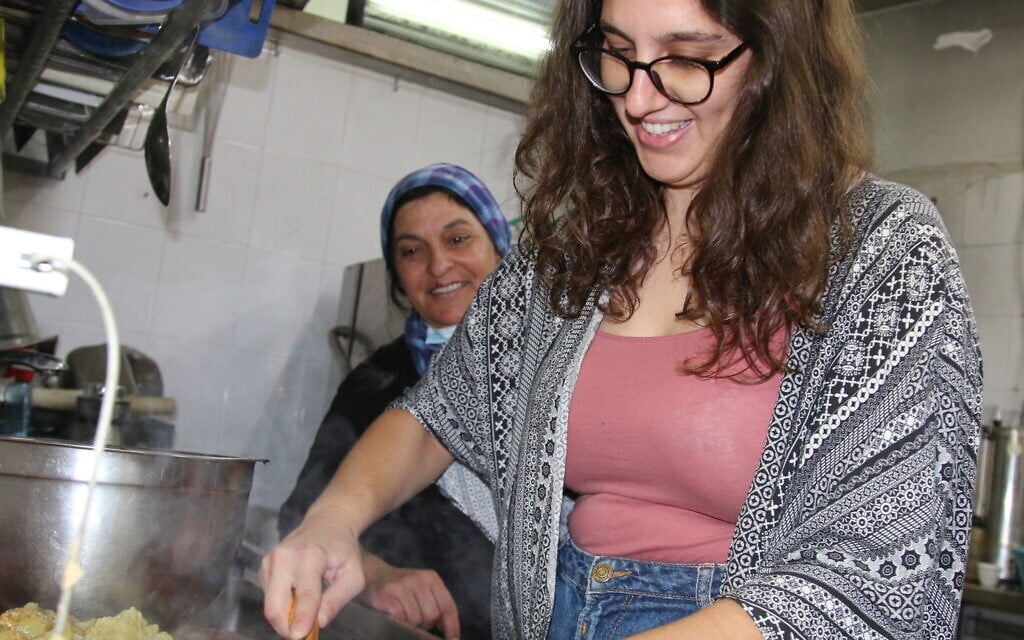 A Blend.ar participant volunteering at a restaurant in Abu Ghosh, October 2021. (Shmuel Bar-Am)