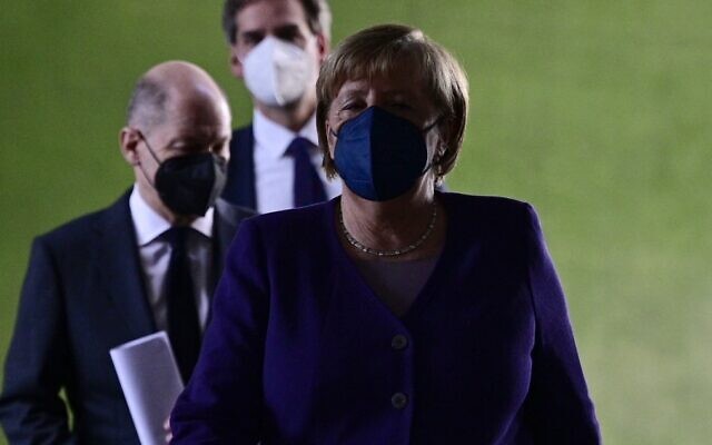 German Chancellor Angela Merkel (R) arrives with her designated successor Olaf Scholz (L) for a press conference following a meeting with the heads of Germany's federal states, at the Chancellery in Berlin, on December 2, 2021. (John MacDougall/Pool/AFP) German Chancellor Angela Merkel (R) arrives with her designated successor Olaf Scholz (L) for a press conference following a meeting with the heads of Germany's federal states, at the Chancellery in Berlin, on December 2, 2021. (John MacDougall/Pool/AFP)