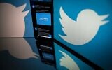 In this file photo taken on October 26, 2020, the logo of US social network Twitter displayed on the screen of a smartphone and a tablet in Toulouse, southern France. (Lionel BONAVENTURE/AFP)