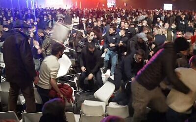 A video grab taken from an AFPTV footage shows SOS Racisme militants (movement against Racism) clashing with supporters of French far-right media pundit and 2022 presidential candidate Eric Zemmour at the end of a campaign rally held in Villepinte, near Paris, on December 5, 2021. (AFP)