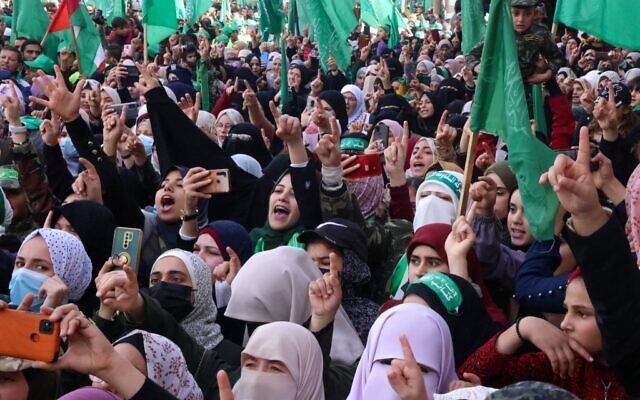 Women gesture during a rally in the Jabaliya refugee camp in the Gaza Strip, marking the 34th anniversary of the founding of Hamas which rules the coastal enclave, December 10, 2021. (Mohammed ABED / AFP) Women gesture during a rally in the Jabaliya refugee camp in the Gaza Strip, marking the 34th anniversary of the founding of Hamas which rules the coastal enclave, December 10, 2021. (Mohammed ABED / AFP)