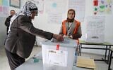 A Palestinian man votes at a polling station in Beit Dajan, east of Nablus in the northern West Bank, on December 11, 2021. (Jaafar Ashtiyeh/AFP)