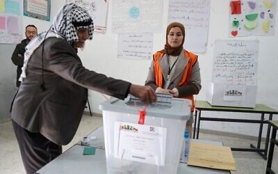 A Palestinian man votes at a polling station in Beit Dajan, east of Nablus in the northern West Bank, on December 11, 2021. (Jaafar Ashtiyeh/AFP) A Palestinian man votes at a polling station in Beit Dajan, east of Nablus in the northern West Bank, on December 11, 2021. (Jaafar Ashtiyeh/AFP)