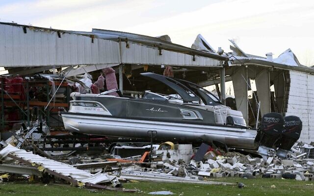 A boat sits at rest after being sucked out of a marine dealership by a tornado in Mayfield, Kentucky, on December 11, 2021. (John Amis / AFP)